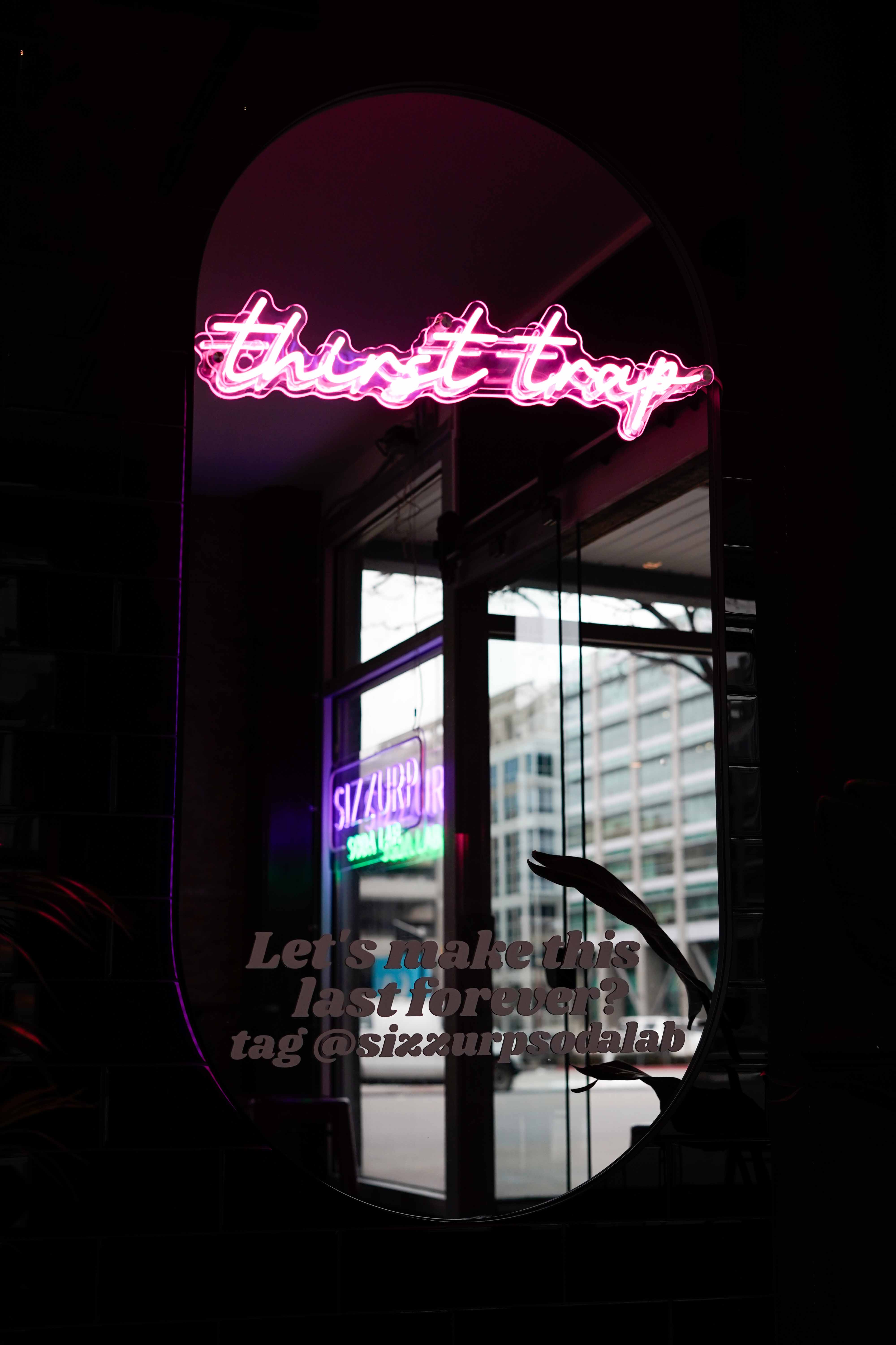 Sizzurp Soda Lab interior with purple neon accent lighting